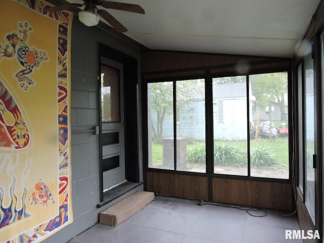 unfurnished sunroom with lofted ceiling and tile patterned floors