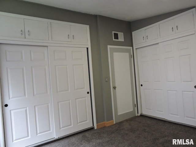 unfurnished bedroom with dark colored carpet