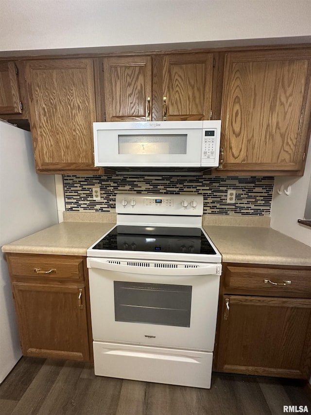kitchen featuring dark wood-style flooring, white appliances, light countertops, brown cabinets, and tasteful backsplash