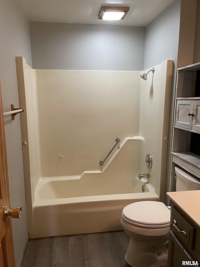 bathroom with vanity, wood finished floors, bathing tub / shower combination, and toilet