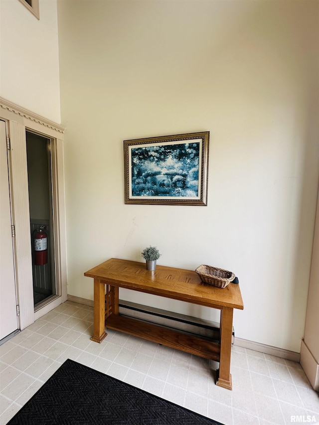 room details featuring baseboards and a fire extinguisher