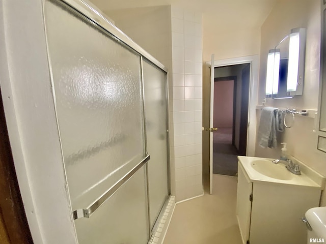bathroom with vanity, toilet, and a shower stall