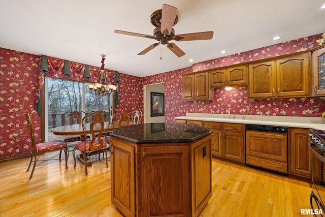 kitchen with wallpapered walls, dishwasher, brown cabinets, and light wood-type flooring