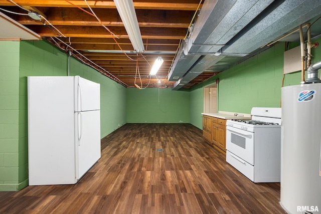 finished basement with freestanding refrigerator, dark wood finished floors, water heater, and concrete block wall