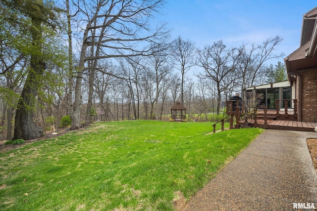 view of yard featuring a deck and a gazebo