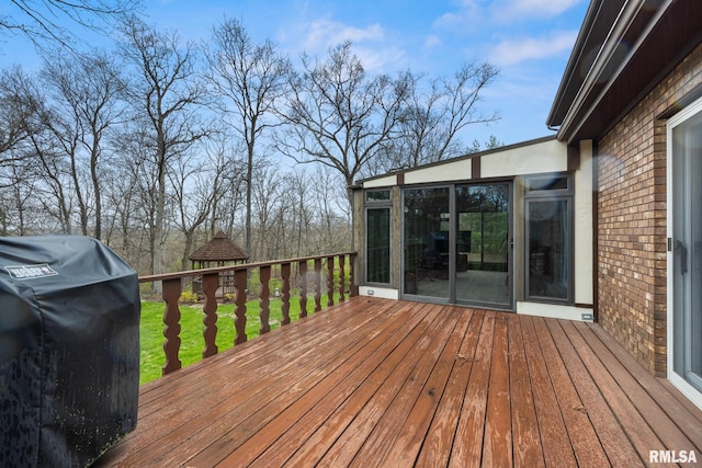 wooden terrace featuring a grill