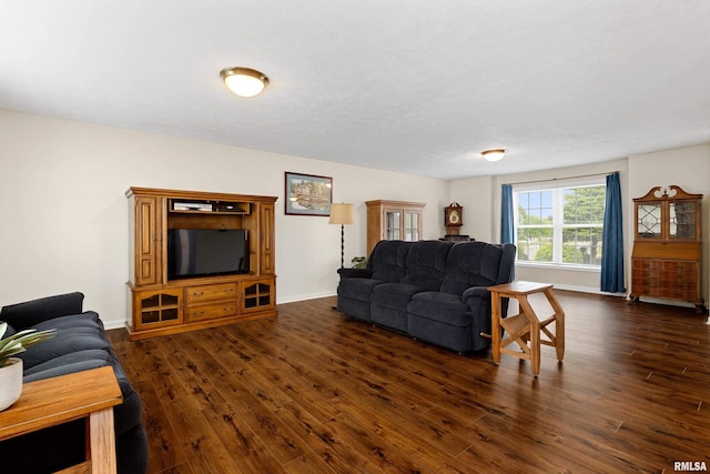 living room with dark wood finished floors and baseboards