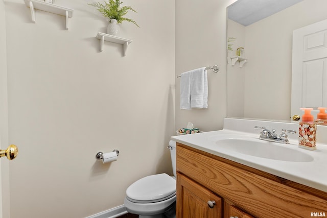 bathroom featuring toilet and vanity