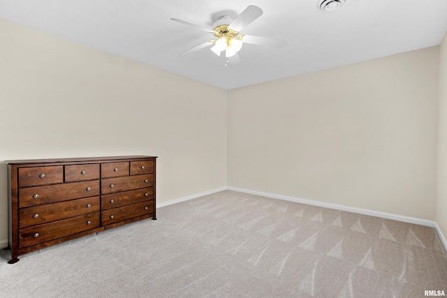 unfurnished bedroom featuring light colored carpet, baseboards, and a ceiling fan