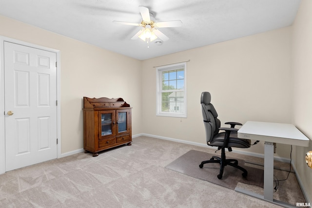office space featuring carpet, a ceiling fan, and baseboards
