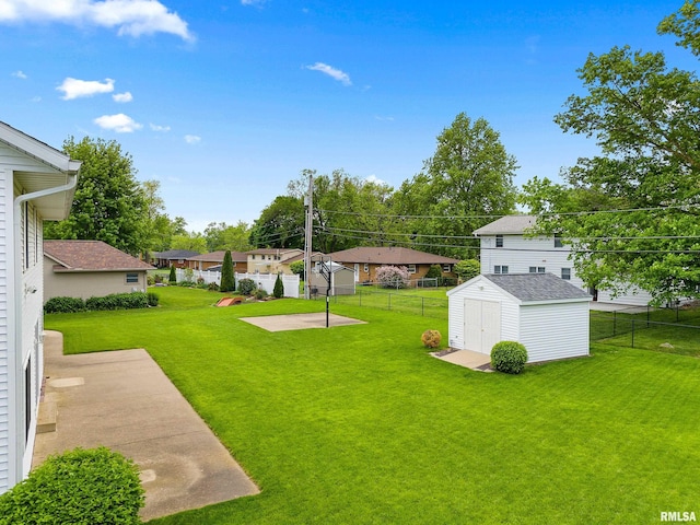 view of yard featuring a shed, an outdoor structure, a residential view, and a patio