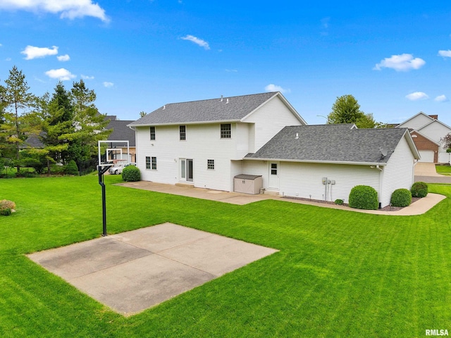 back of property featuring a patio, a lawn, and roof with shingles