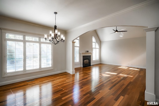 unfurnished living room with hardwood / wood-style flooring, ceiling fan with notable chandelier, visible vents, arched walkways, and baseboards