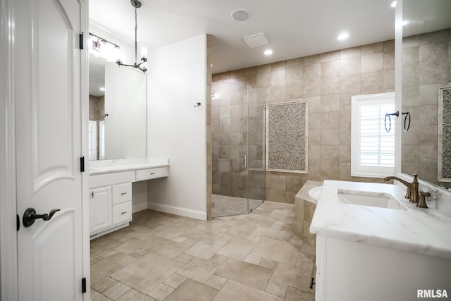 bathroom with vanity, baseboards, a shower stall, and recessed lighting
