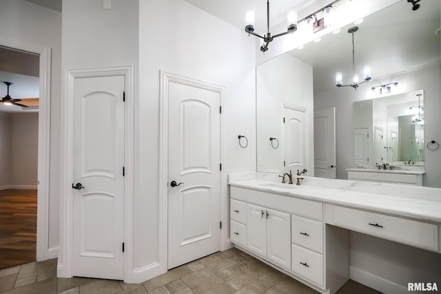 bathroom featuring vanity and ceiling fan with notable chandelier