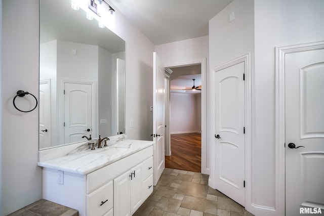 bathroom featuring ceiling fan, vanity, and stone finish floor