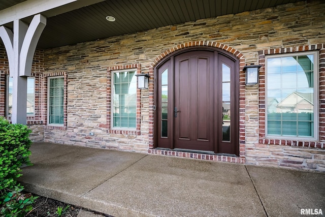 doorway to property featuring stone siding