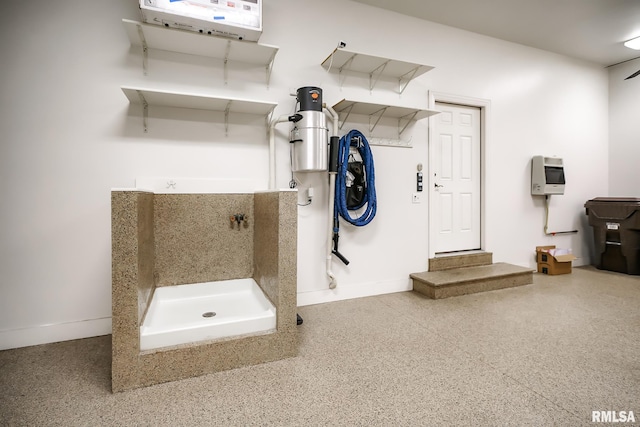 bathroom with baseboards and walk in shower