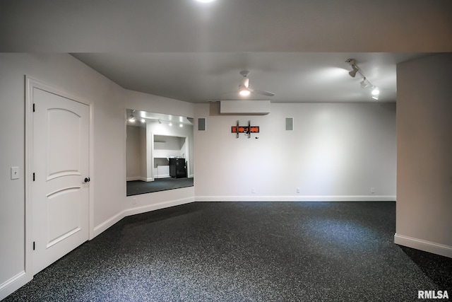 interior space featuring baseboards and dark speckled floor