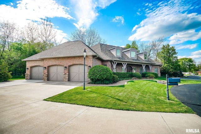 view of front of property featuring a garage, concrete driveway, a front lawn, brick siding, and roof with shingles