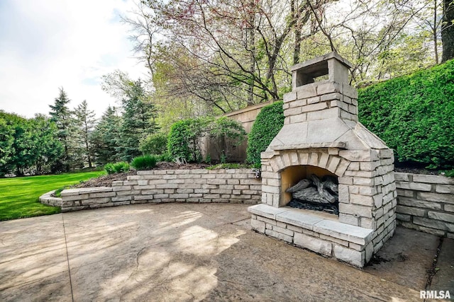 view of patio with an outdoor stone fireplace