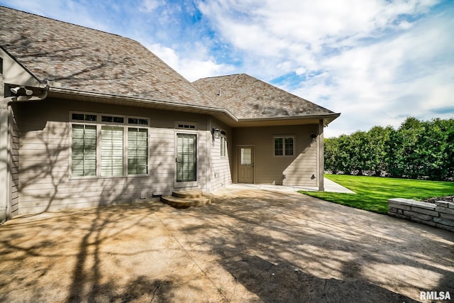 back of house featuring a patio area and a lawn