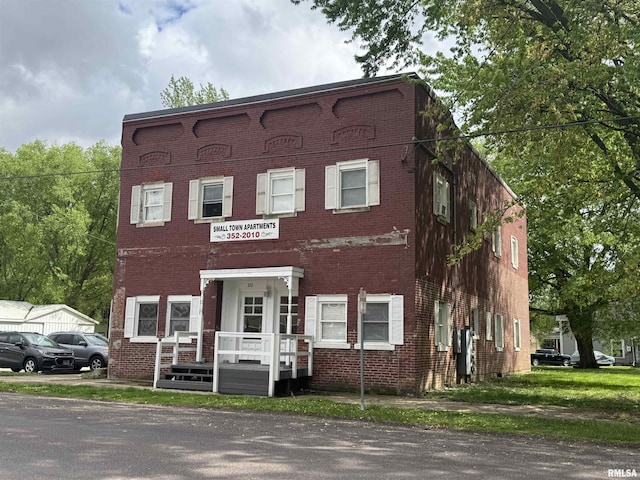 view of property featuring brick siding