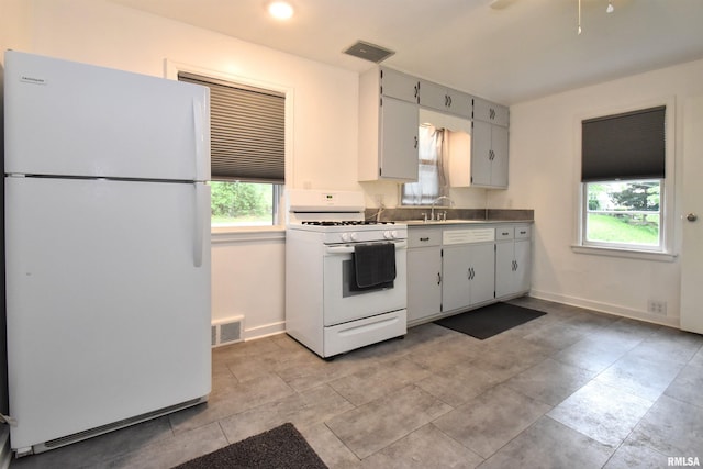 420 W Garfield Ave, Bartonville, IL 61607 - kitchen with white appliances and baseboards