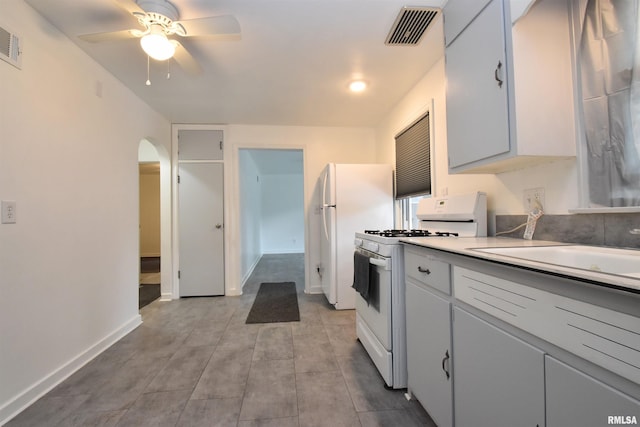 420 W Garfield Ave, Bartonville, IL 61607 - kitchen featuring white appliances, arched walkways, ceiling fan, light countertops, and baseboards