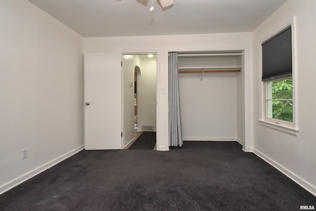 420 W Garfield Ave, Bartonville, IL 61607 - unfurnished bedroom with dark carpet, a closet, a ceiling fan, and baseboards
