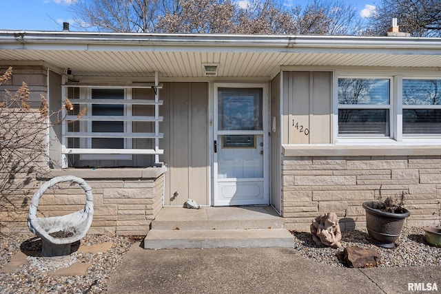 1420 N 10th St, Pekin, IL 61554 - entrance to property with stone siding, a porch, and board and batten siding