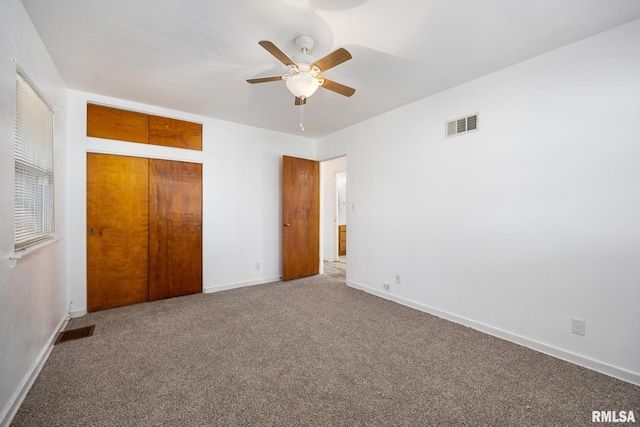 1420 N 10th St, Pekin, IL 61554 - unfurnished bedroom featuring baseboards, ceiling fan, visible vents, and carpet floors