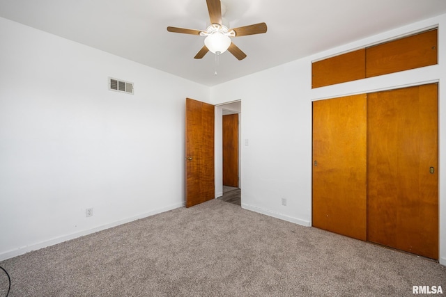 1420 N 10th St, Pekin, IL 61554 - unfurnished bedroom with a ceiling fan, a closet, baseboards, carpet flooring, and visible vents