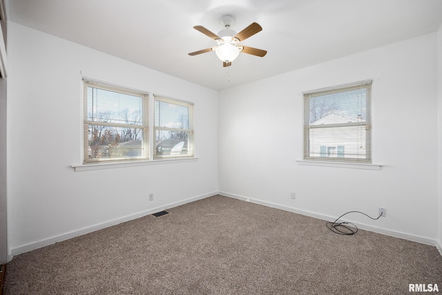 1420 N 10th St, Pekin, IL 61554 - spare room with a ceiling fan, carpet flooring, visible vents, and baseboards
