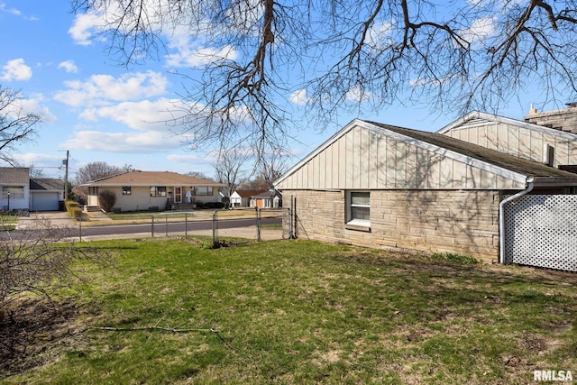 1420 N 10th St, Pekin, IL 61554 - view of home's exterior with a yard, fence, stone siding, and board and batten siding