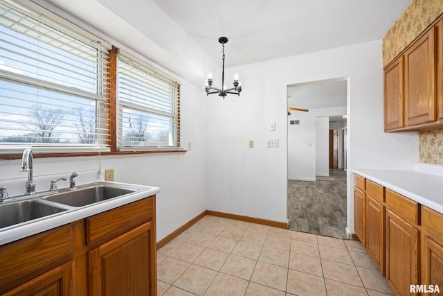 1420 N 10th St, Pekin, IL 61554 - kitchen featuring brown cabinets, hanging light fixtures, light countertops, and a sink