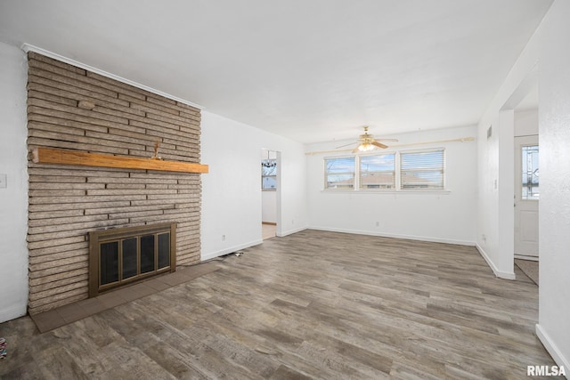 1420 N 10th St, Pekin, IL 61554 - unfurnished living room with baseboards, a fireplace, ceiling fan, and wood finished floors