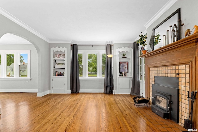 2714 W Kenwood Ave, West Peoria, IL 61604 - unfurnished living room with wood finished floors, crown molding, healthy amount of natural light, and baseboards