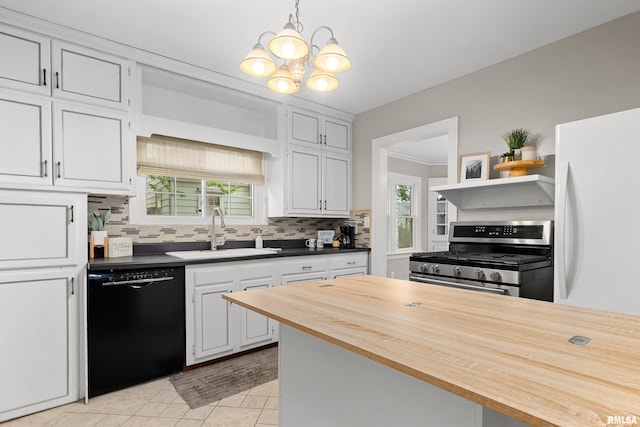 2714 W Kenwood Ave, West Peoria, IL 61604 - kitchen with stainless steel range with gas cooktop, black dishwasher, a sink, decorative backsplash, and white cabinets