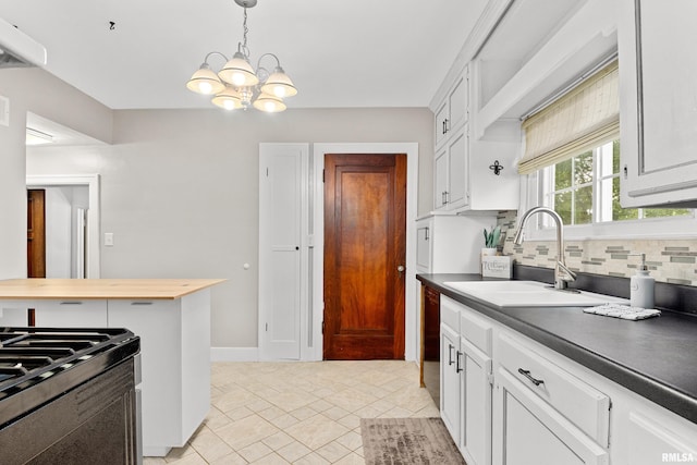 2714 W Kenwood Ave, West Peoria, IL 61604 - kitchen with a sink, a chandelier, decorative backsplash, range with gas cooktop, and decorative light fixtures