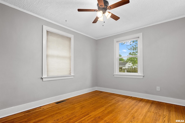 2714 W Kenwood Ave, West Peoria, IL 61604 - unfurnished room with crown molding, a textured ceiling, baseboards, light wood finished floors, and ceiling fan