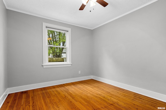 2714 W Kenwood Ave, West Peoria, IL 61604 - empty room featuring crown molding, a ceiling fan, wood finished floors, baseboards, and a textured ceiling