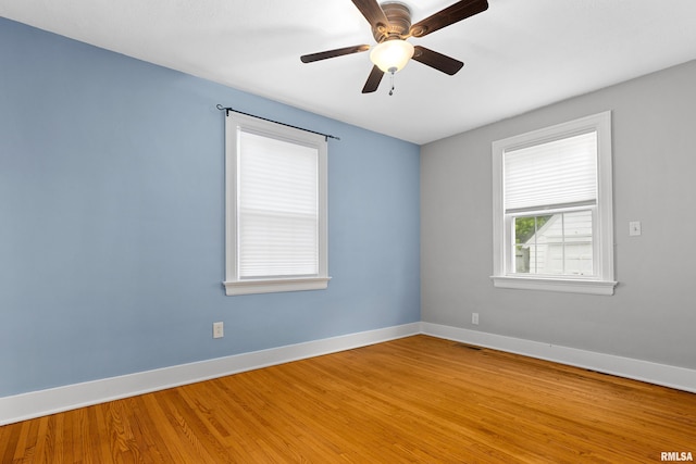 2714 W Kenwood Ave, West Peoria, IL 61604 - unfurnished room with baseboards, wood finished floors, and a ceiling fan