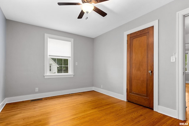 2714 W Kenwood Ave, West Peoria, IL 61604 - empty room featuring light wood-style flooring, baseboards, and a ceiling fan