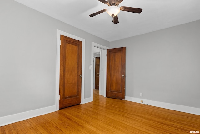 2714 W Kenwood Ave, West Peoria, IL 61604 - unfurnished room featuring baseboards, light wood-style floors, and ceiling fan