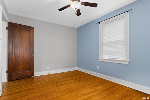 2714 W Kenwood Ave, West Peoria, IL 61604 - spare room featuring wood finished floors, a ceiling fan, and baseboards