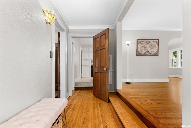 2714 W Kenwood Ave, West Peoria, IL 61604 - hallway with light wood-style floors, crown molding, arched walkways, and baseboards