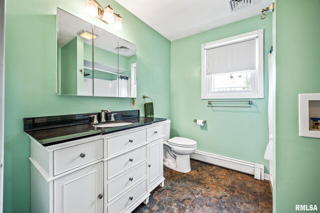 21016 N US Highway 24, Canton, IL 61520 - bathroom with stone finish flooring, vanity, visible vents, and a baseboard heating unit