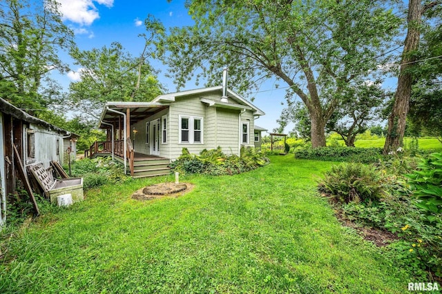 21016 N US Highway 24, Canton, IL 61520 - exterior space with a deck and a lawn
