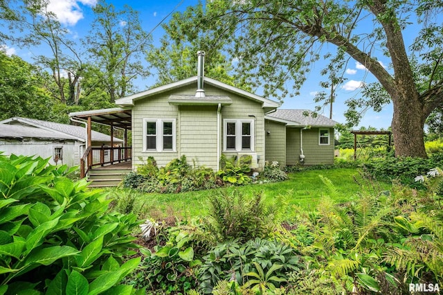 21016 N US Highway 24, Canton, IL 61520 - back of house featuring a lawn and a wooden deck